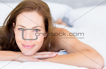 Closeup portrait of a pretty woman lying in bed