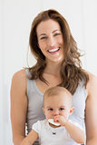 Closeup portrait of a smiling mother and baby