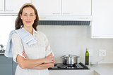 Portrait of a confident smiling woman in kitchen