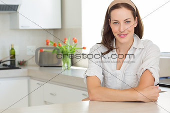 Portrait of a smiling young woman in kitchen