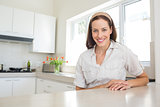 Portrait of a smiling woman in kitchen