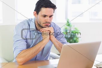 Businessman looking at laptop