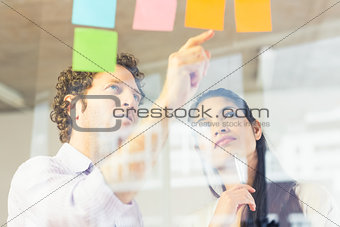 Business people reading adhesive notes