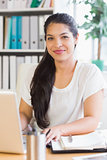 Businesswoman with laptop at desk