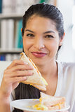 Businesswoman eating sandwich in office