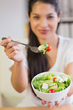 Businesswoman offering salad in office