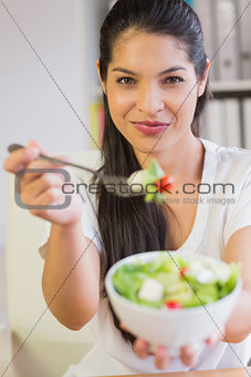 Beautiful businesswoman offering salad