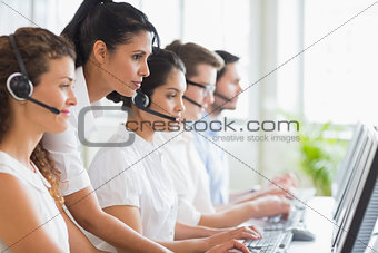 Manager assisting her staffs in call center
