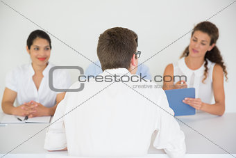 Man being interviewed by business people
