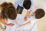 Business people analyzing blueprint