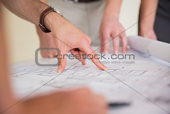 Businessman pointing on blueprint