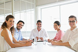 Confident business people at conference table
