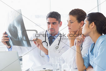 Male doctor discussing xray with colleagues