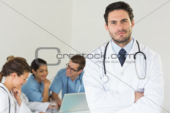Male doctor standing arms crossed