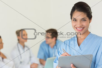 Beautiful nurse holding clipboard