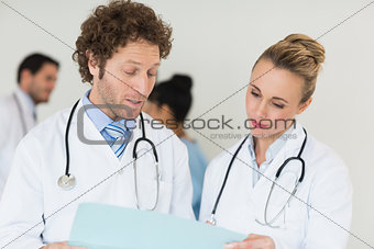 Medical team discussing over file