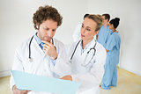 Doctors analyzing file in hospital