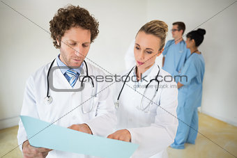 Doctors reading file