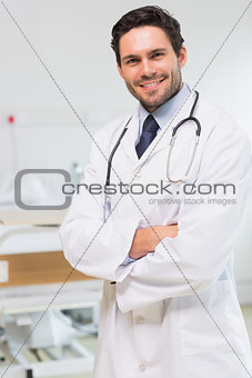 Handsome doctor standing arms crossed