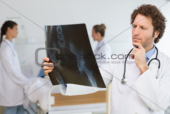 Concentrated doctor examining Xray