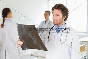 Male doctor checking Xray
