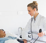 Doctor examining patients blood pressure
