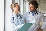 Happy doctors discussing over file