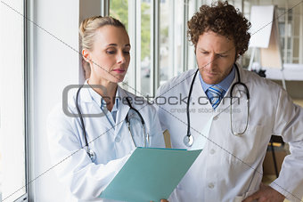Doctors discussing over file