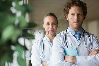 Confident doctors standing arms crossed