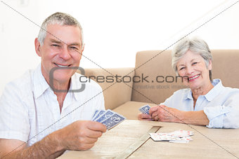 Happy couple playing cards