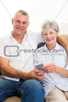 Senior couple with with mobile phone