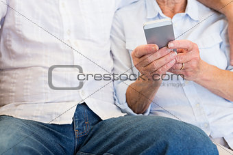 Senior woman text messaging on mobile phone