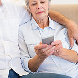 Woman reading text message on smartphone