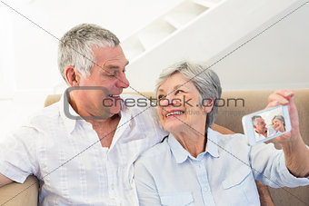Senior couple taking selfie through cellphone