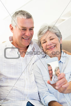 Senior couple taking picture through mobile phone