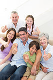 Happy multigeneration family gesturing thumbs up