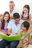 Multigeneration family reading book
