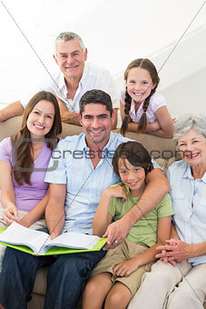 Happy multigeneration family with book