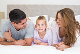 Girl with parents in bed