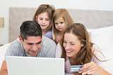 Family with credit card shopping online