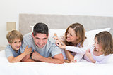 Playful family in bed