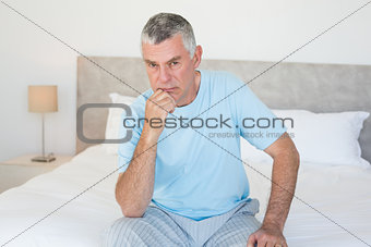 Portrait of senior man on bed