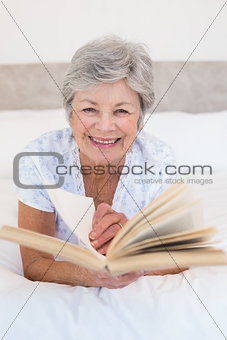 Senior woman turning story book pages