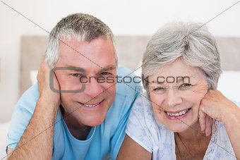 Senior couple smiling in bed