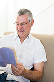Senior man reading book at home
