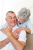 Loving senior woman embracing husband