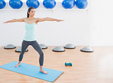 Sporty woman stretching hands in fitness studio