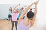 Sporty class with joined hands in fitness studio