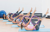 Sporty people with exercising rings in fitness studio