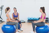 Sporty young women sitting on exercise balls